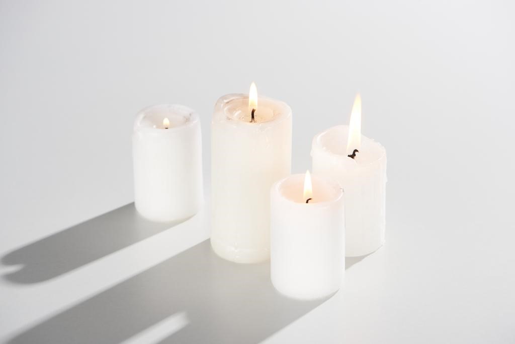 candles-glowing-white-background